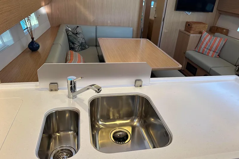 Slide: The Image of Modern kitchen in 2022 Bavaria C45 yacht with stove, dual sinks, and wooden cabinetry. - 31