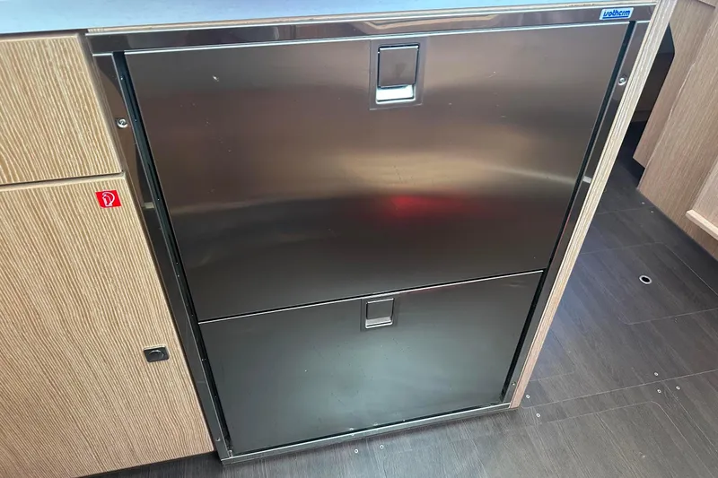 Slide: The Image of Modern kitchen interior of 2022 Bavaria C45 yacht with stove, sink, and wooden cabinetry. - 35