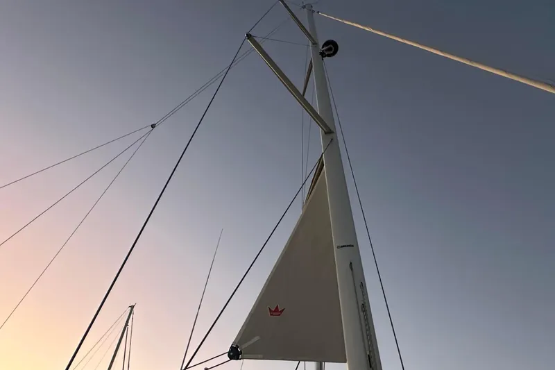 Slide: The Image of Bavaria C45 yacht anchored in marina, 2022 model, with scenic mountain backdrop. - 5