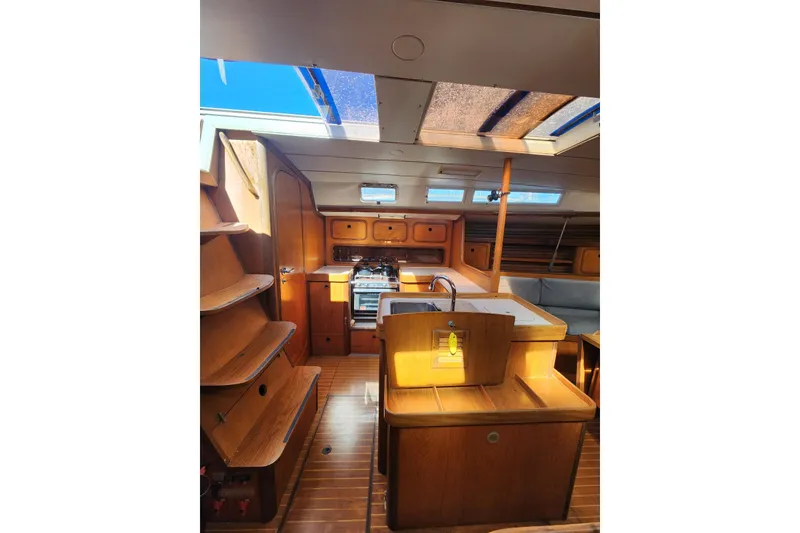 Slide: The Image of Interior of 1988 Beneteau First 405 sailboat with wooden cabinetry and skylight. - 11
