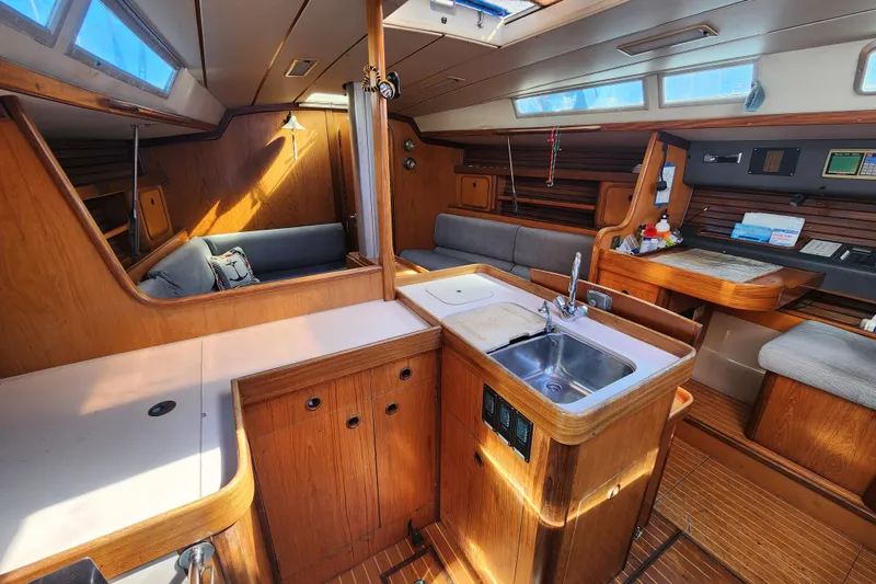 Slide: The Image of Interior of 1988 Beneteau First 405 yacht with wood finish and modern amenities. - 12