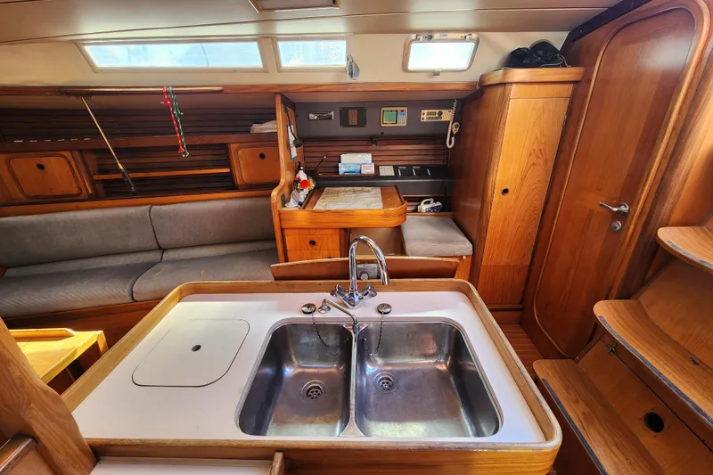 Slide: The Image of Interior of 1988 Beneteau First 405 yacht with wooden cabinetry and stainless steel sink. - 13