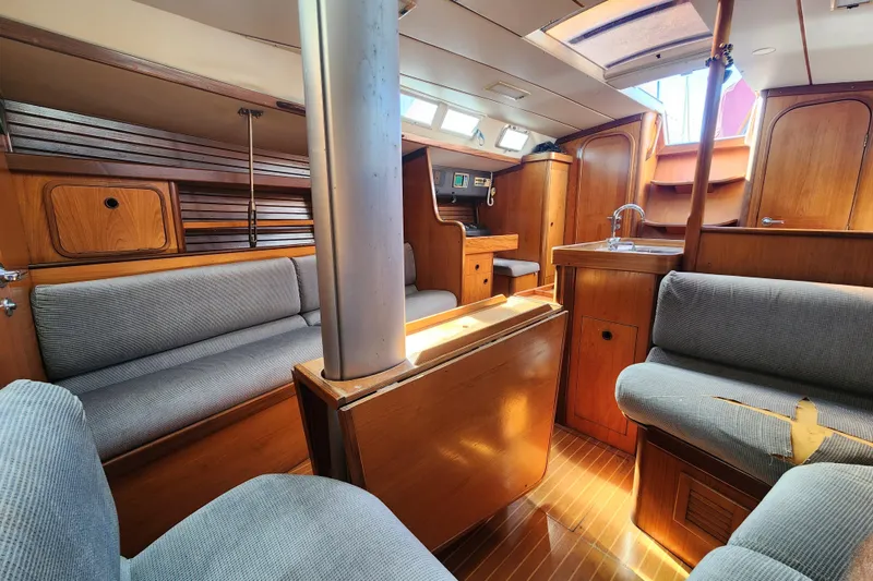 Slide: The Image of Interior of 1988 Beneteau First 405 sailboat with wood finish and gray seating. - 17
