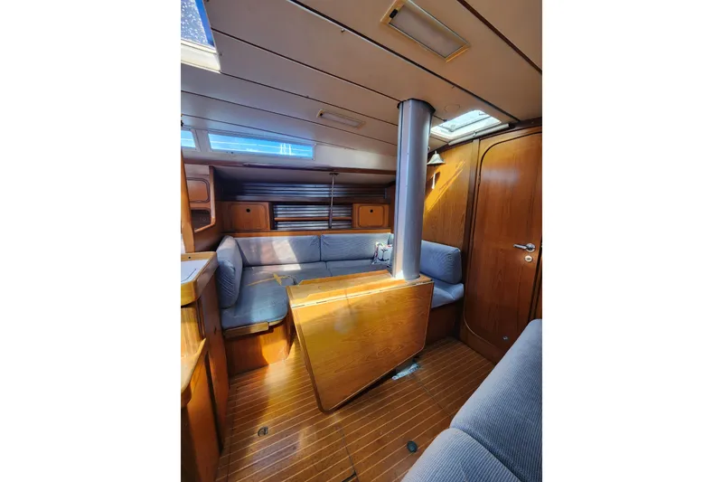 Slide: The Image of Interior of 1988 Beneteau First 405 sailboat with wood finish and seating area. - 18