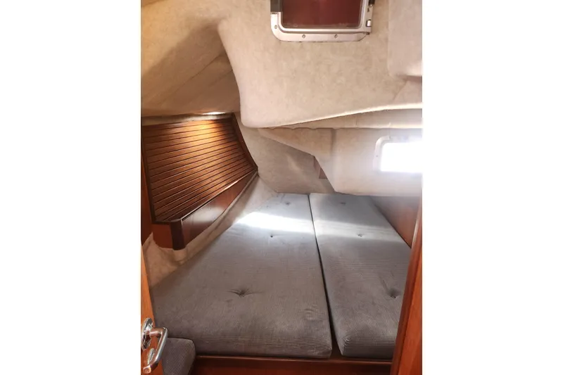 Slide: The Image of Interior cabin of 1988 Beneteau First 405 sailboat with twin berths and wooden accents. - 22