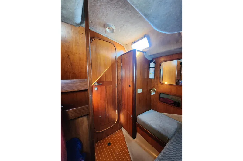 Slide: The Image of Cozy interior of 1988 Beneteau First 405 sailboat with wooden finishes and seating area. - 25