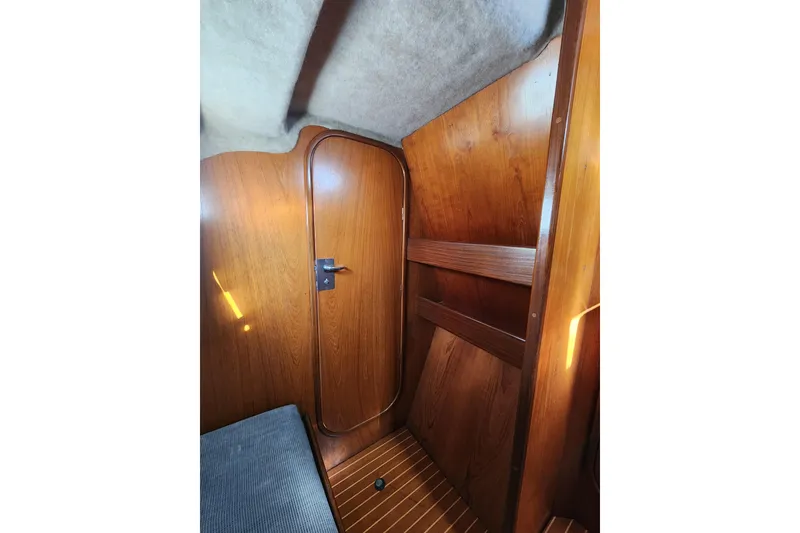 Slide: The Image of Interior of 1988 Beneteau First 405 sailboat with wooden door and paneling. - 27