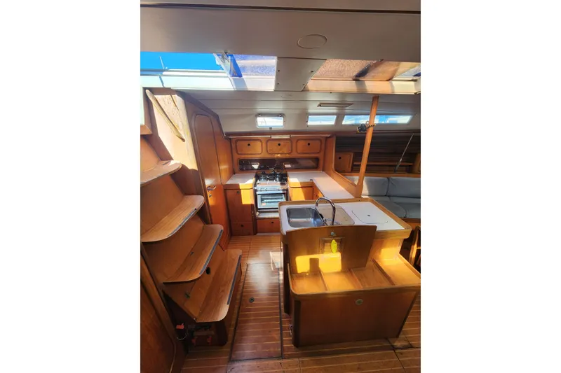 Slide: The Image of Interior of 1988 Beneteau First 405 sailboat with wooden cabinetry and compact kitchen. - 29
