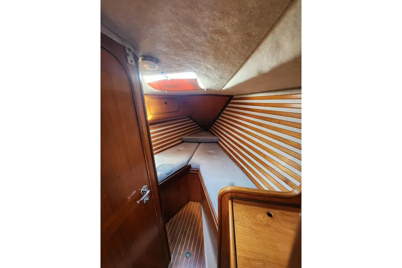 Slide: The Image of Interior cabin of 1988 Beneteau First 405 sailboat with wooden paneling and cozy berth. - 32