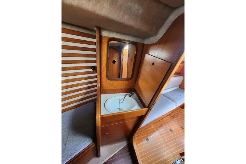 Slide: The Image of Interior of 1988 Beneteau First 405 yacht with wooden finish and compact sink. - 36