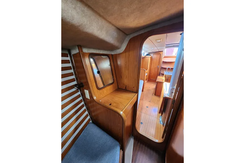 Slide: The Image of Interior of 1988 Beneteau First 405 sailboat, featuring wood paneling and cozy cabin space. - 37