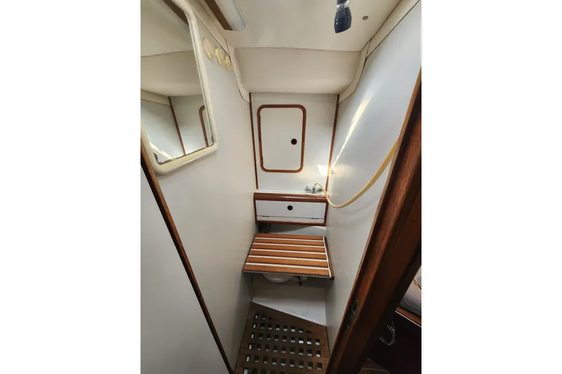 Slide: The Image of 1988 Beneteau First 405 yacht bathroom with wooden accents and mirror. - 39
