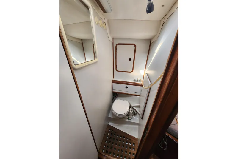 Slide: The Image of Interior of 1988 Beneteau First 405 yacht bathroom with toilet and mirror. - 40