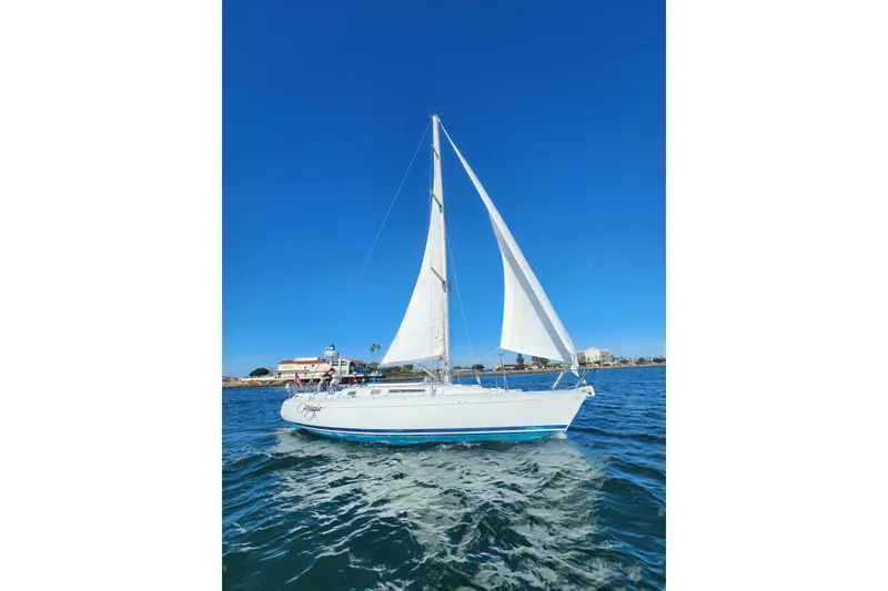 Slide: The Image of 1988 Beneteau First 405 sailboat cruising on clear blue waters under a sunny sky. - 42