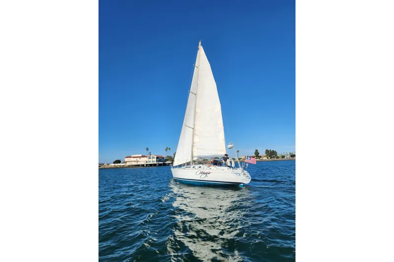 Slide: The Image of 1988 Beneteau First 405 sailboat cruising on clear blue water under a sunny sky. - 45
