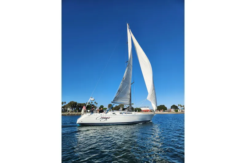 Slide: The Image of 1988 Beneteau First 405 sailboat on calm water under clear blue sky. - 54