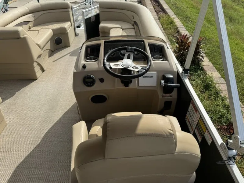 Slide: The Image of 2018 Bennington 21 SLX boat interior with beige seating and steering console. - 7
