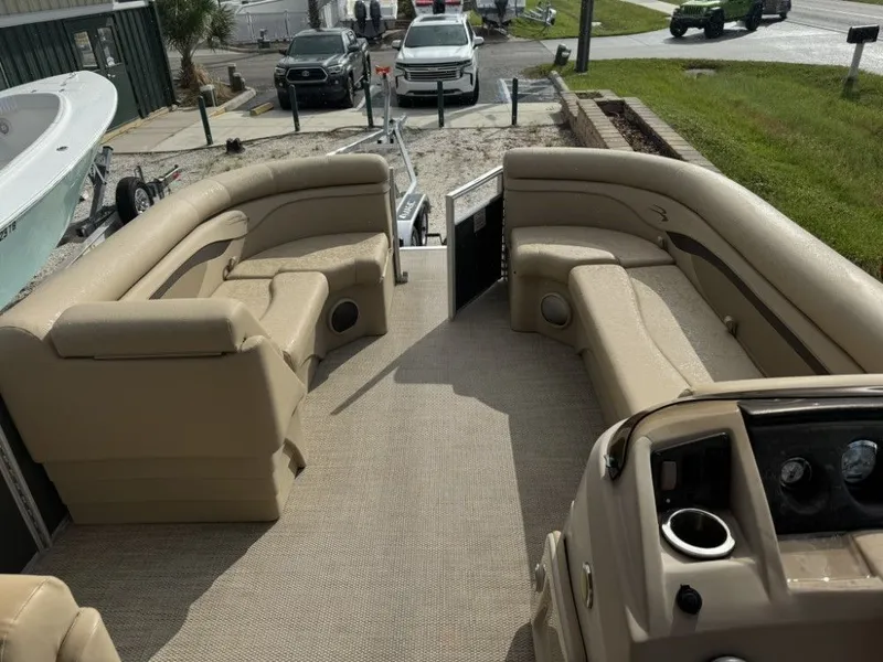 Slide: The Image of 2018 Bennington 21 SLX pontoon boat interior with beige seating and dashboard. - 8