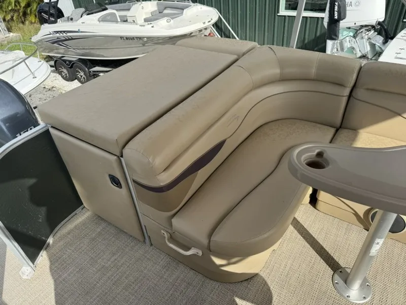 Slide: The Image of 2018 Bennington 21 SLX boat interior with beige seating and cup holder table. - 9