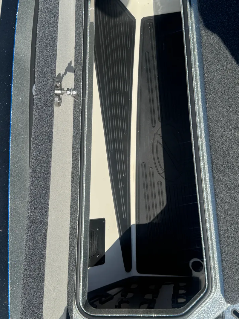 Slide: The Image of Open storage compartment in 2019 Ranger Z520L boat, showing interior details. - 23