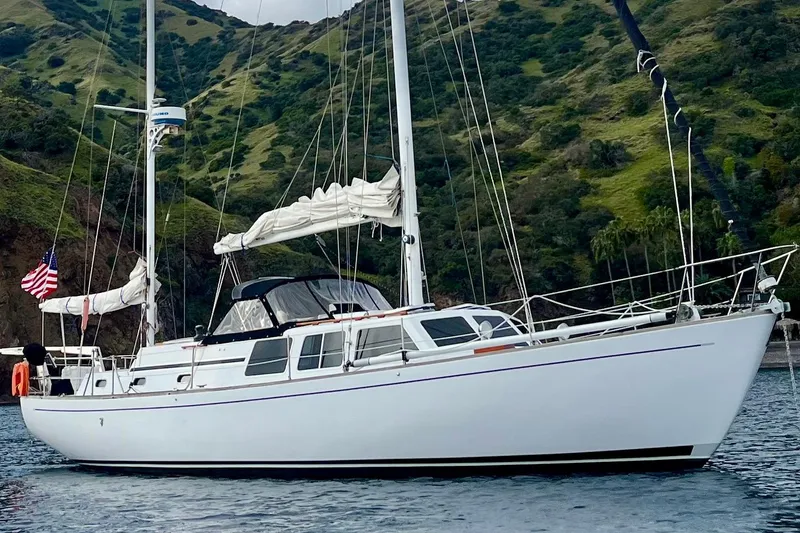 The Image of 1973 CAL 246 sailboat anchored near lush green hills. - 0