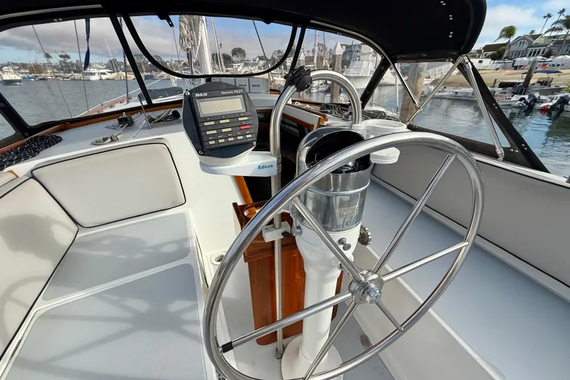 Slide: The Image of Steering wheel and navigation equipment on a 1973 CAL 246 sailboat in a marina. - 11