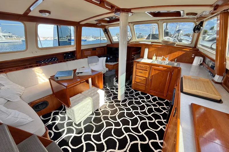 Slide: The Image of Interior of a 1973 CAL 246 yacht with wooden cabinetry and patterned carpet. - 12