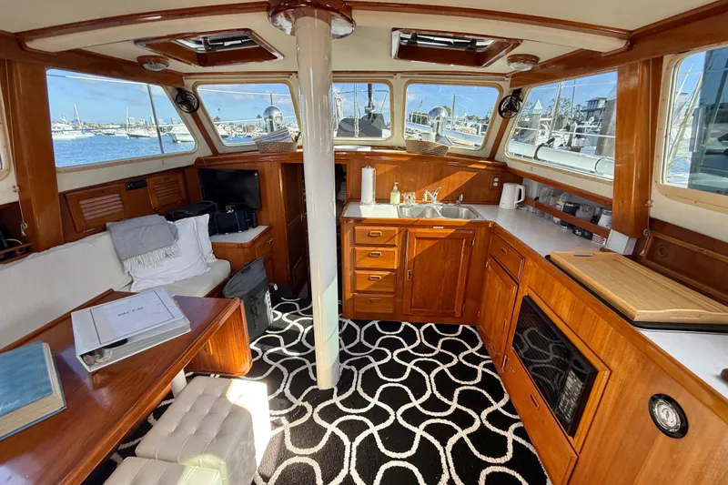 Slide: The Image of Interior of a 1973 CAL 246 boat with wooden cabinetry and nautical decor. - 13