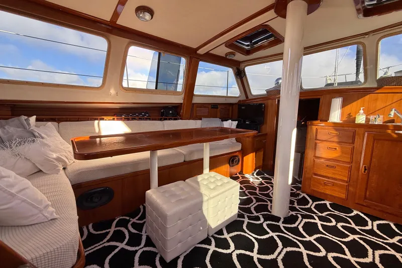 Slide: The Image of Luxurious 1973 CAL 246 yacht interior with wooden furnishings and patterned carpet. - 17