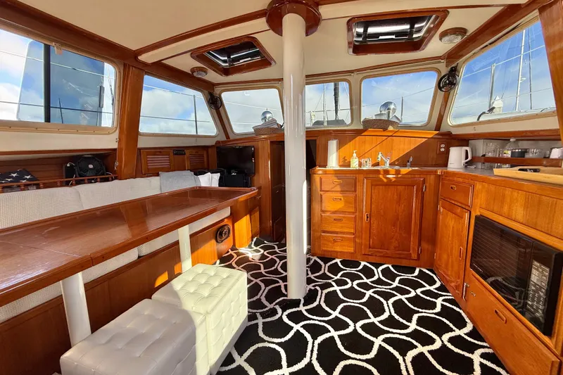Slide: The Image of Interior of a 1973 CAL 246 sailboat with wooden cabinetry and modern amenities. - 20