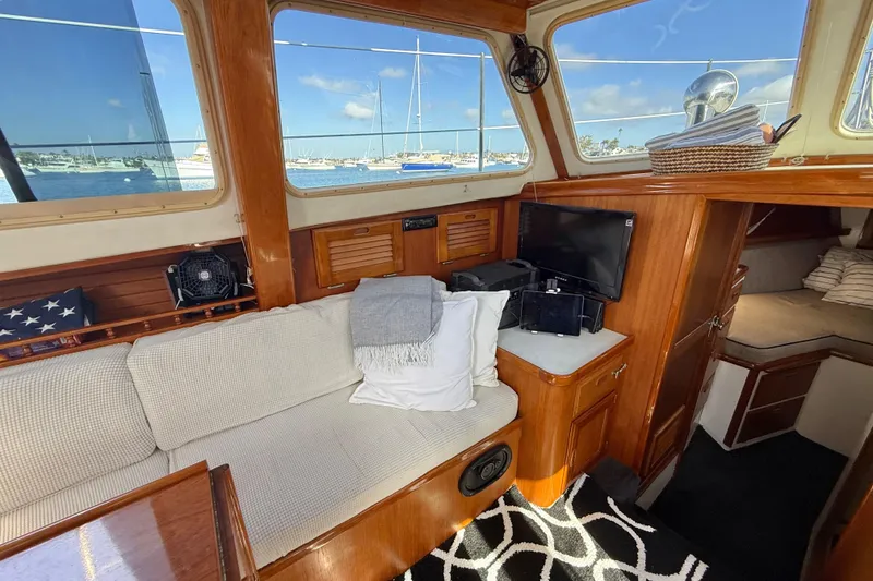 Slide: The Image of Interior of a 1973 CAL 246 boat with cozy seating and nautical decor. - 23