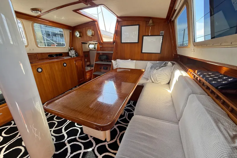 Slide: The Image of Luxurious 1973 CAL 246 yacht interior with wooden furnishings and cozy seating area. - 24
