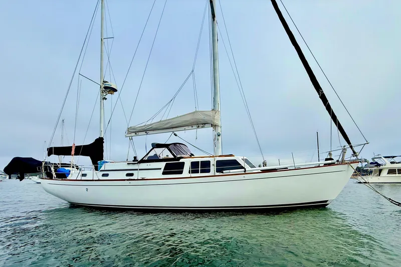Slide: The Image of 1973 CAL 246 sailboat anchored in calm waters, side view. - 3