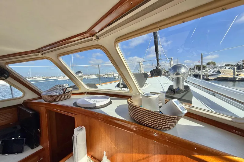 Slide: The Image of Interior view of a 1973 CAL 246 sailboat with marina in the background. - 33