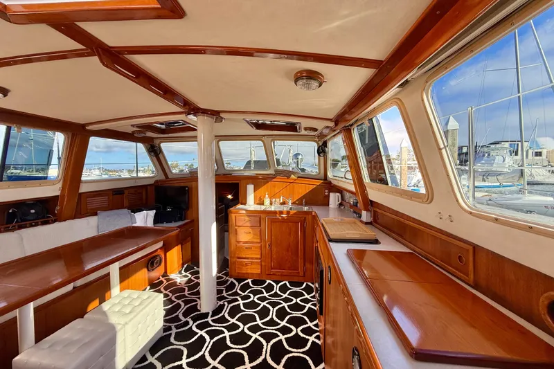 Slide: The Image of Luxurious 1973 CAL 246 yacht interior with wooden furnishings and panoramic windows. - 34