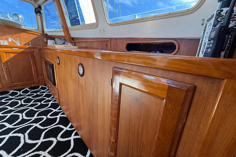 Slide: The Image of Interior of 1973 CAL 246 boat with polished wood cabinetry and patterned carpet. - 35