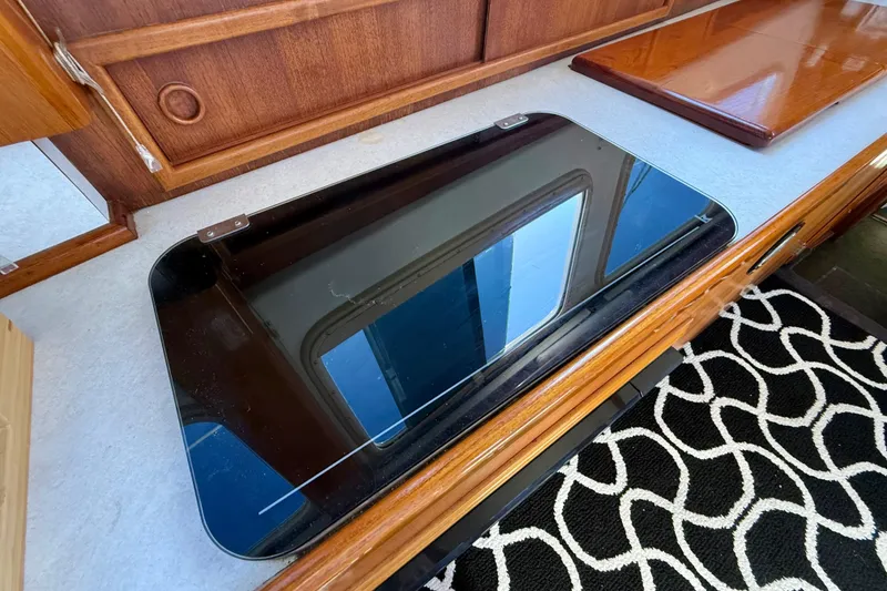 Slide: The Image of 1973 CAL 246 interior with wooden cabinetry and sleek black countertop. - 36