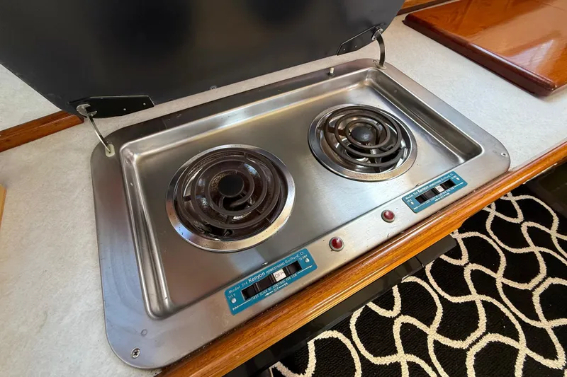 Slide: The Image of 1973 CAL 246 stove with dual electric burners in a compact kitchen setting. - 37