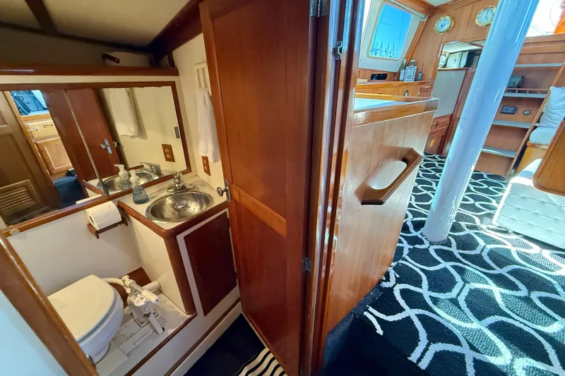 Slide: The Image of 1973 CAL 246 yacht interior with bathroom, sink, and nautical decor. - 42