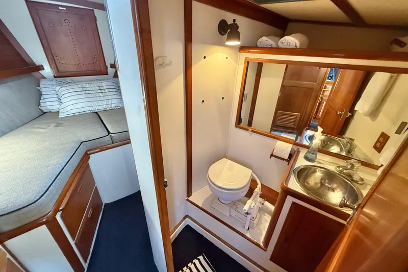 Slide: The Image of 1973 CAL 246 yacht interior with cozy cabin, bed, and compact bathroom. - 44
