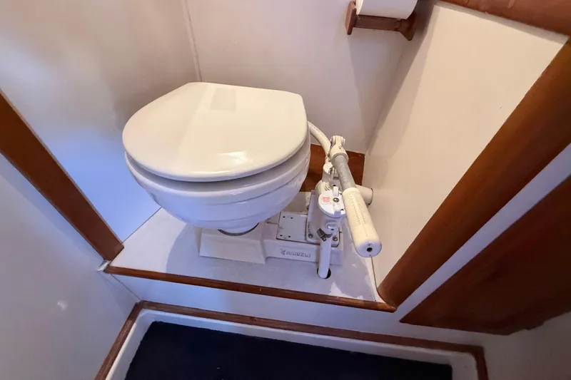 Slide: The Image of 1973 CAL 246 marine toilet with manual pump in compact bathroom setting. - 46