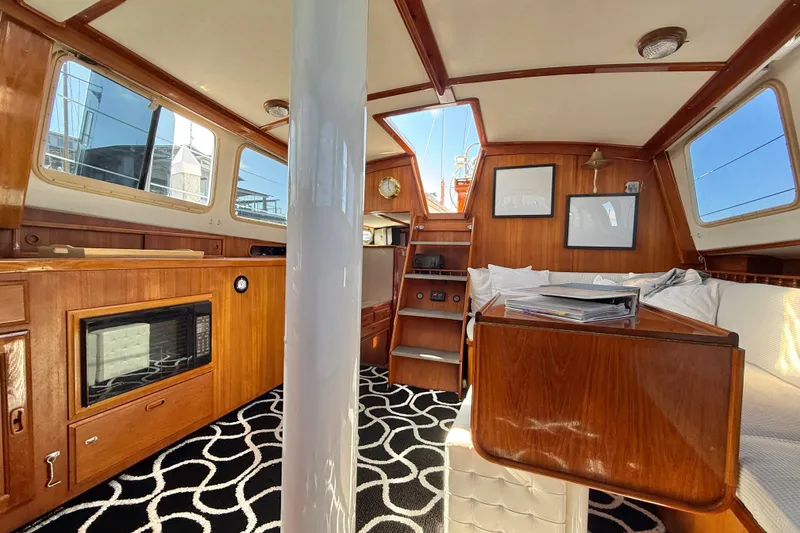Slide: The Image of 1973 CAL 246 yacht interior with wooden cabinetry, cozy seating, and nautical decor. - 47