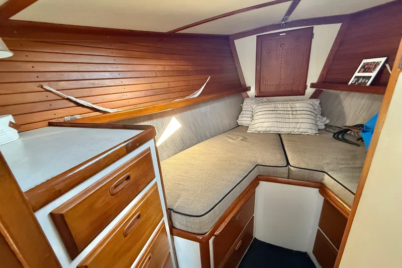 Slide: The Image of Cozy 1973 CAL 246 boat cabin with wooden interior and cushioned seating. - 48