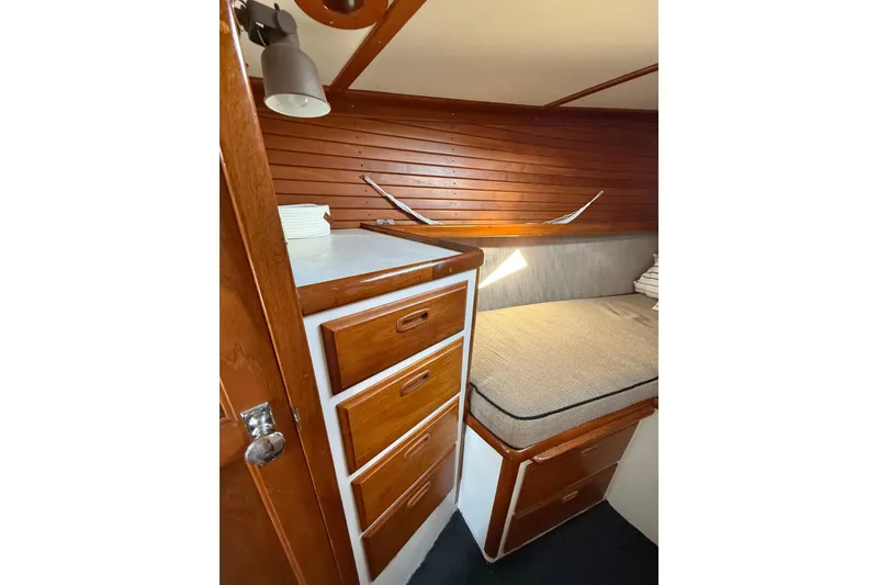 Slide: The Image of 1973 CAL 246 boat interior with wooden cabinetry and cozy sleeping area. - 50