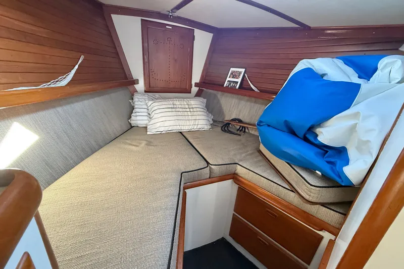 Slide: The Image of Cozy cabin interior of a 1973 CAL 246 sailboat with cushions and wooden accents. - 51