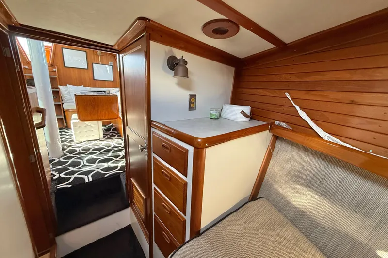 Slide: The Image of 1973 CAL 246 sailboat interior with wood paneling and cozy seating area. - 52