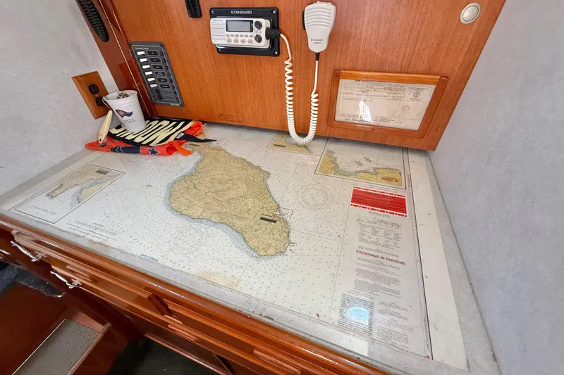 Slide: The Image of Navigation station with map, radio, and cup on a 1973 CAL 246 sailboat. - 53
