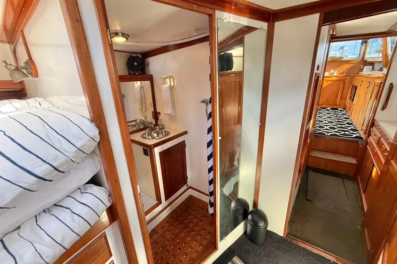 Slide: The Image of 1973 CAL 246 yacht interior with cozy cabin, wooden finishes, and compact bathroom. - 56