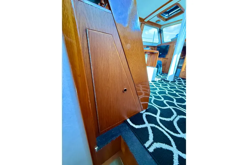 Slide: The Image of Interior of a 1973 CAL 246 boat with wooden paneling and patterned carpet. - 61