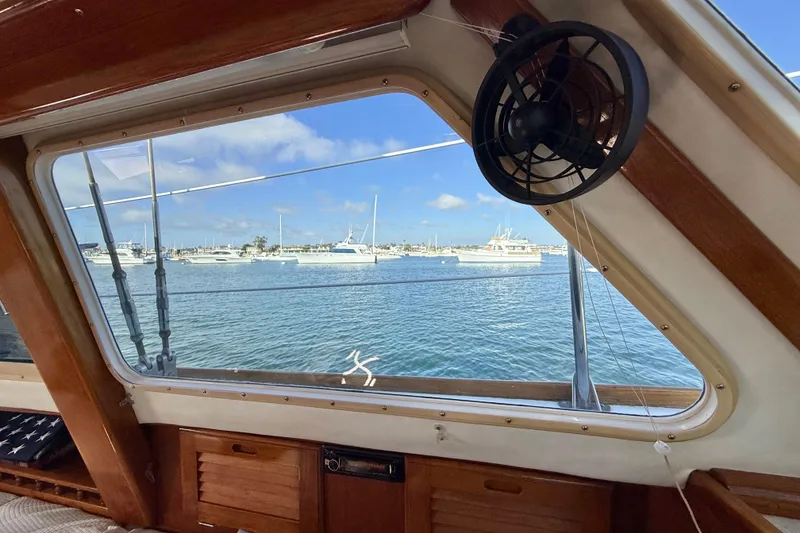 Slide: The Image of View from inside a 1973 CAL 246 boat, overlooking a marina with sailboats. - 63
